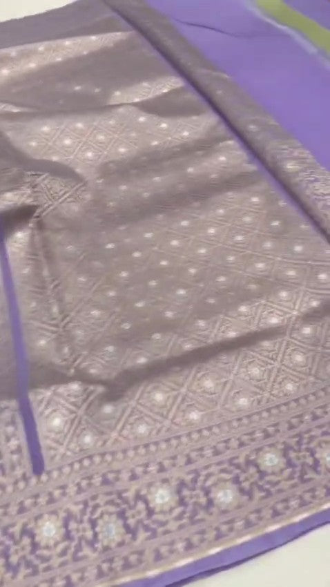 Lavender Banarasi mercerised cotton saree with intricate gold and silver Sona Rupa zari weaving, posed beautifully in an elegant setting.