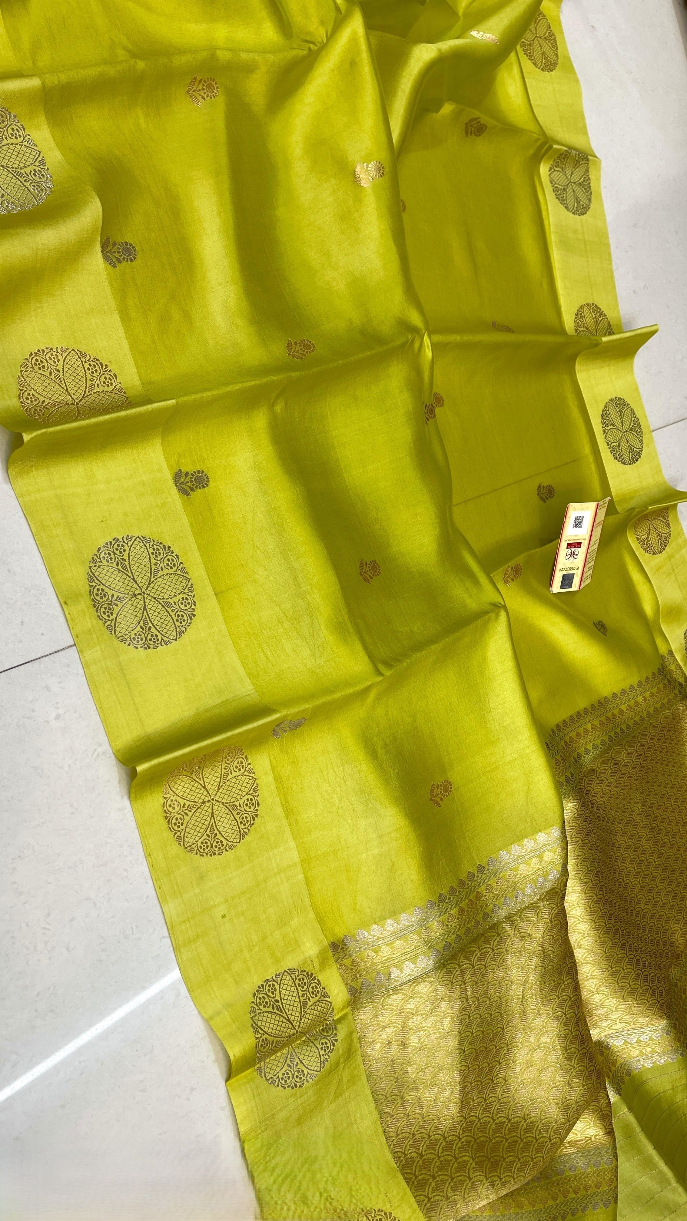 Lime Green Banarasi Raw Mango Silk saree featuring intricate gold zari floral butis and a wide gold Mashru border, paired with a contrast emerald green blouse.
