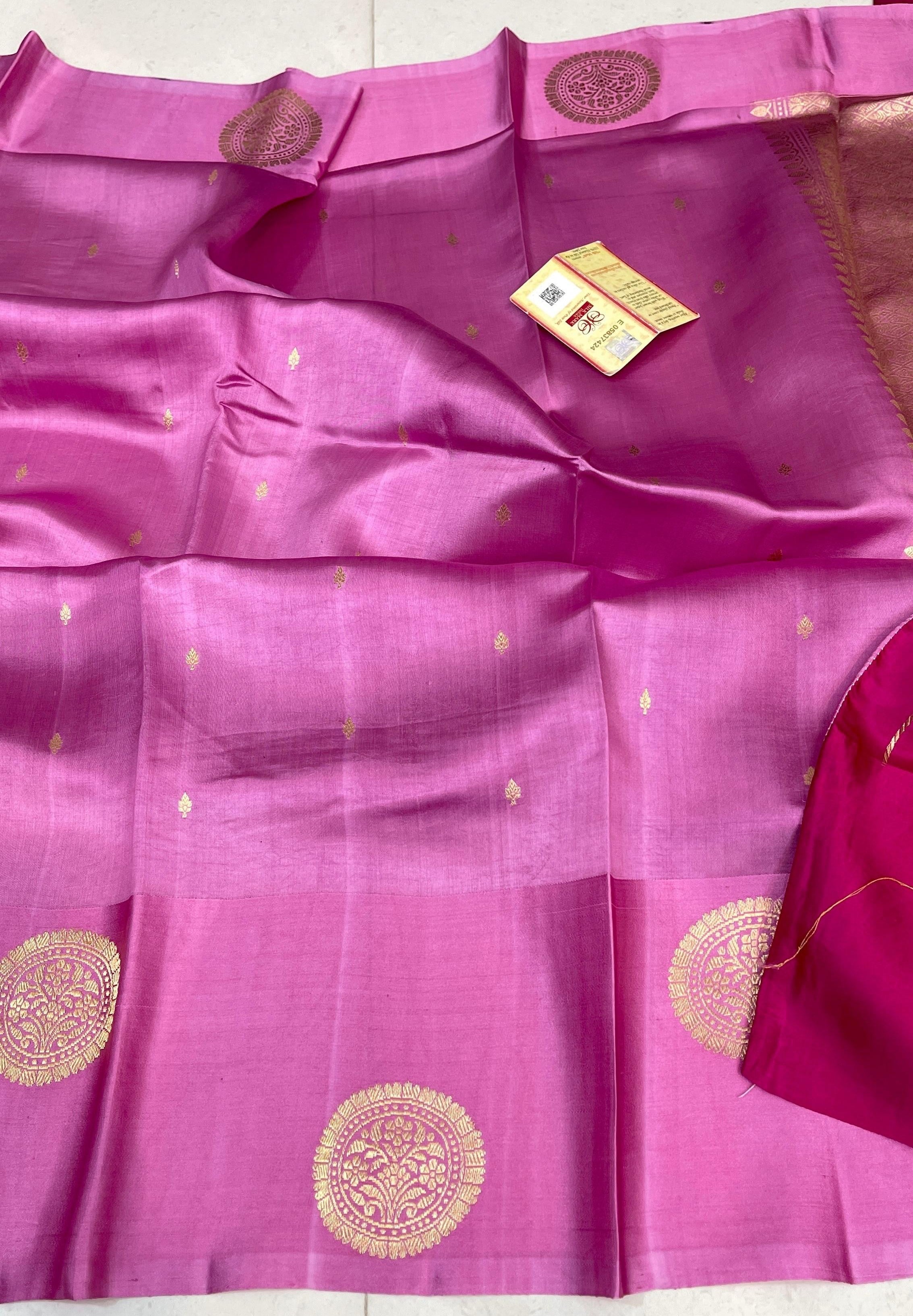 Vibrant Hot Pink Banarasi Raw Mango Silk saree with intricate gold zari floral motifs and a luxurious gold Mashru border, paired with a matching blouse.