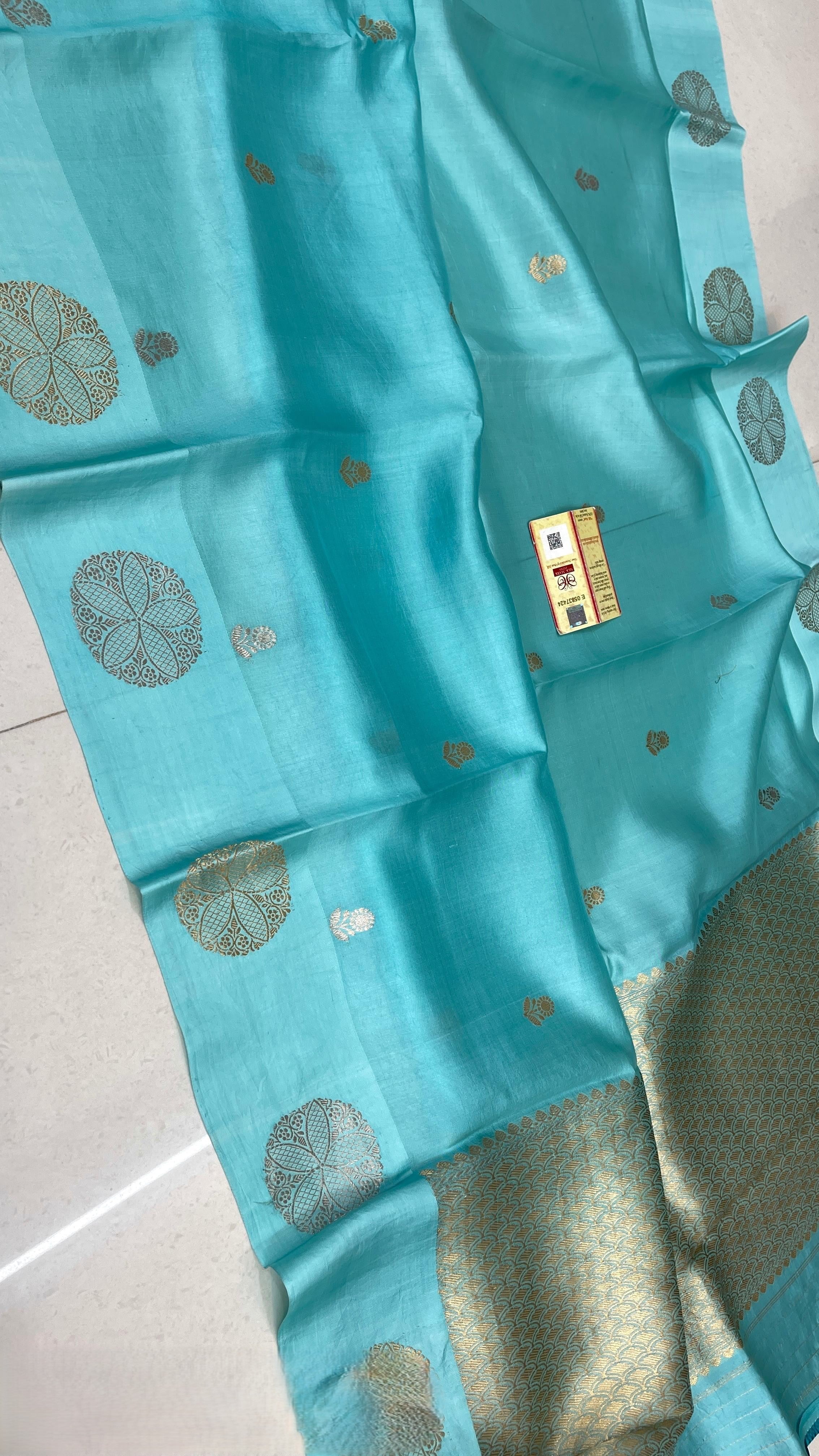 Luminous Turquoise Banarasi Raw Mango Silk saree with intricate gold zari work and a traditional Mashru border, paired with an elegant blouse.