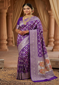 A deep royal purple Banarasi handloom pure Katan silk saree featuring vibrant multicolored Meenakari floral motifs and an elaborate silver zari border and pallu.