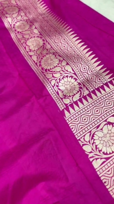 A stunning pink Banarasi handloom pure Katan silk saree adorned with multicolored Meenakari floral patterns and a rich silver zari border, perfect for weddings.