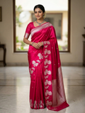A model gracefully presenting a luxurious hot pink Banarasi Mashru silk saree adorned with intricate silver zari floral motifs and a detailed geometric border.