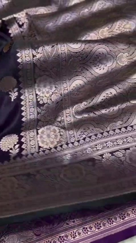 Dark purple Banarasi Mashru soft silk saree featuring elaborate silver and gold zari borders and matching floral motifs.