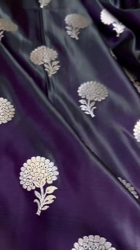 Dark purple Banarasi Mashru soft silk saree featuring elaborate silver and gold zari borders and matching floral motifs.