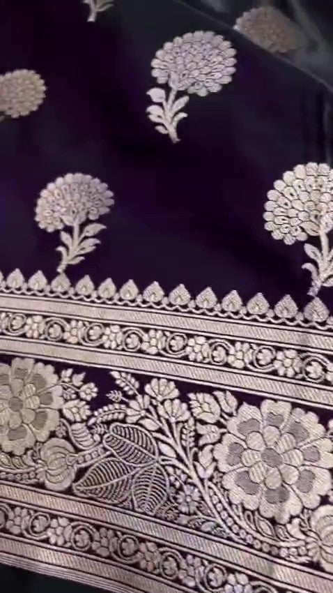 Dark purple Banarasi Mashru soft silk saree featuring elaborate silver and gold zari borders and matching floral motifs.