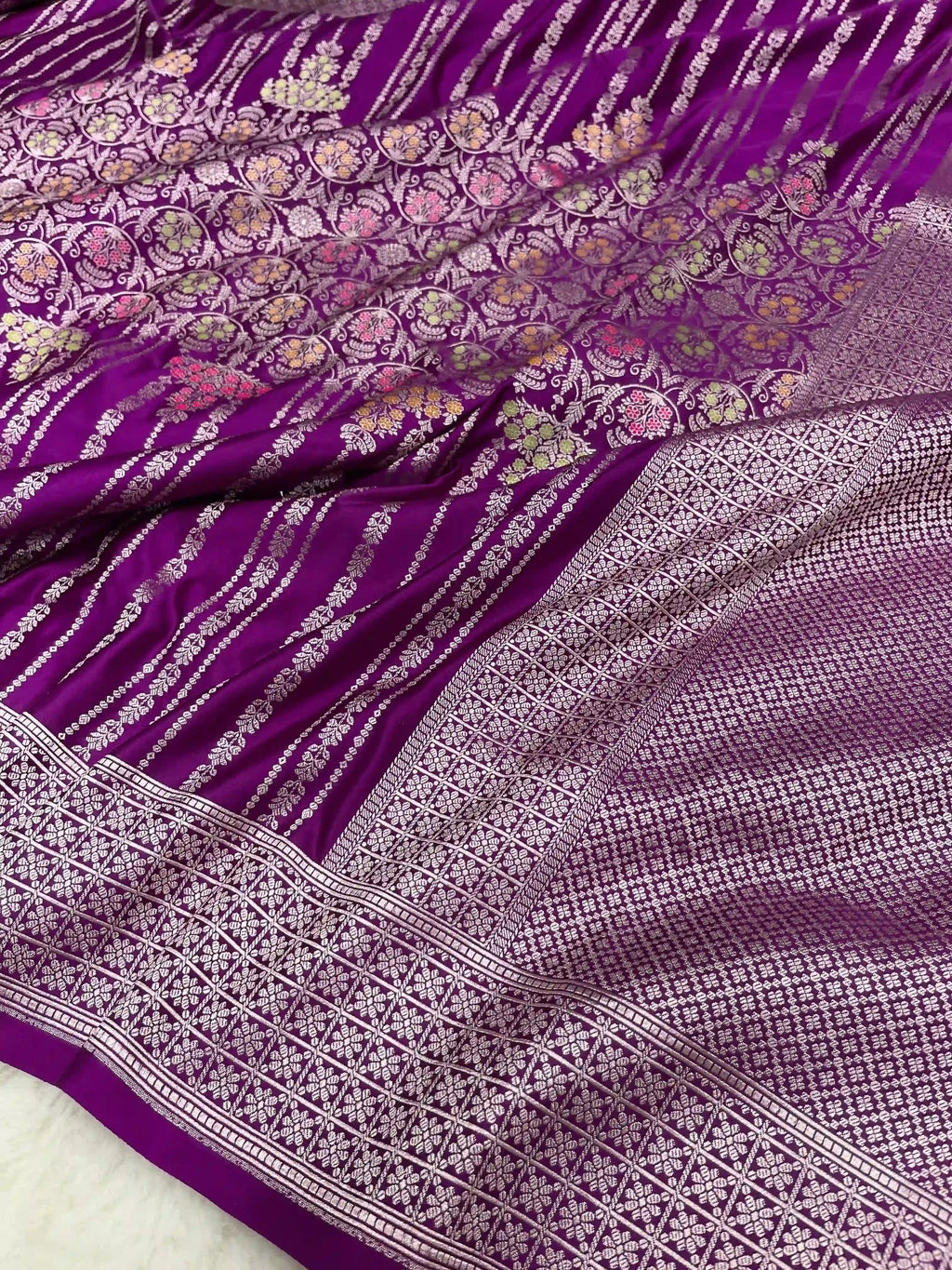 Purple Banarasi mashru soft silk saree featuring intricate golden zari floral jangla weaving, vertical pinstripes, meenakari highlights, and a ornate zari border.