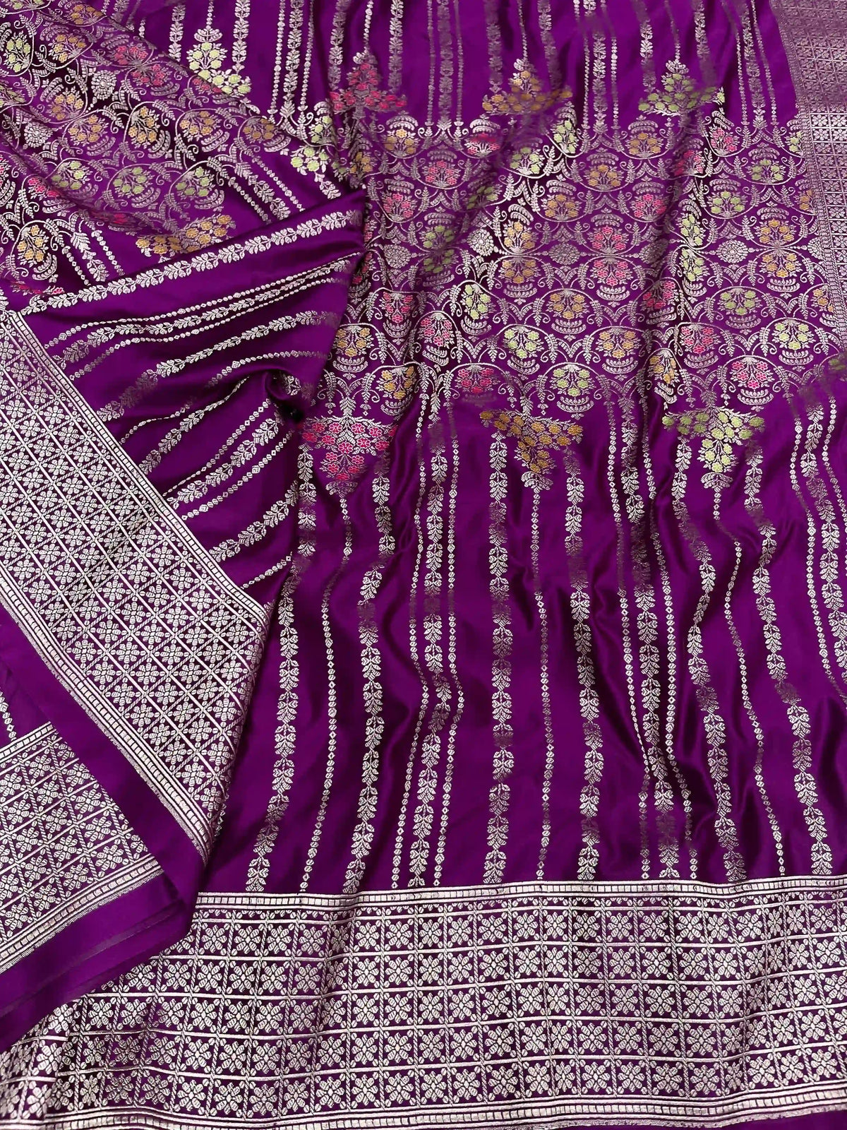 Purple Banarasi mashru soft silk saree featuring intricate golden zari floral jangla weaving, vertical pinstripes, meenakari highlights, and a ornate zari border.