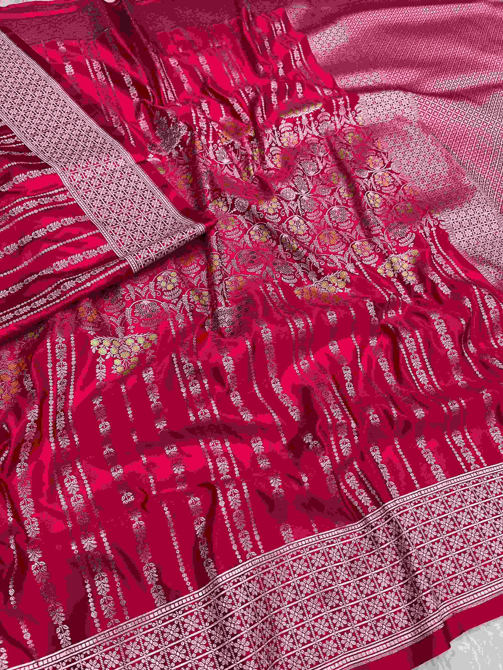 Rani Pink Banarasi mashru soft silk saree woven with intricate golden zari floral jangla jaal, vertical pinstripes, meenakari accents, and geometric borders.