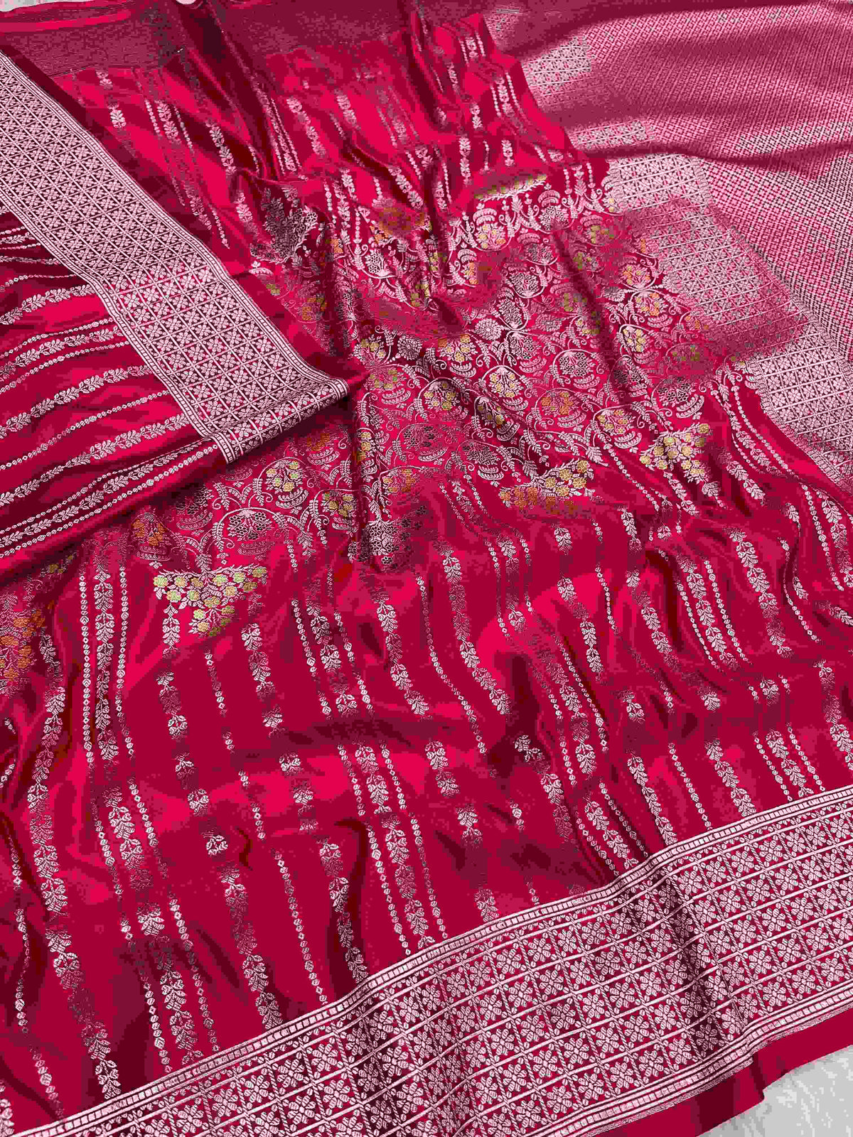 Rani Pink Banarasi mashru soft silk saree woven with intricate golden zari floral jangla jaal, vertical pinstripes, meenakari accents, and geometric borders.
