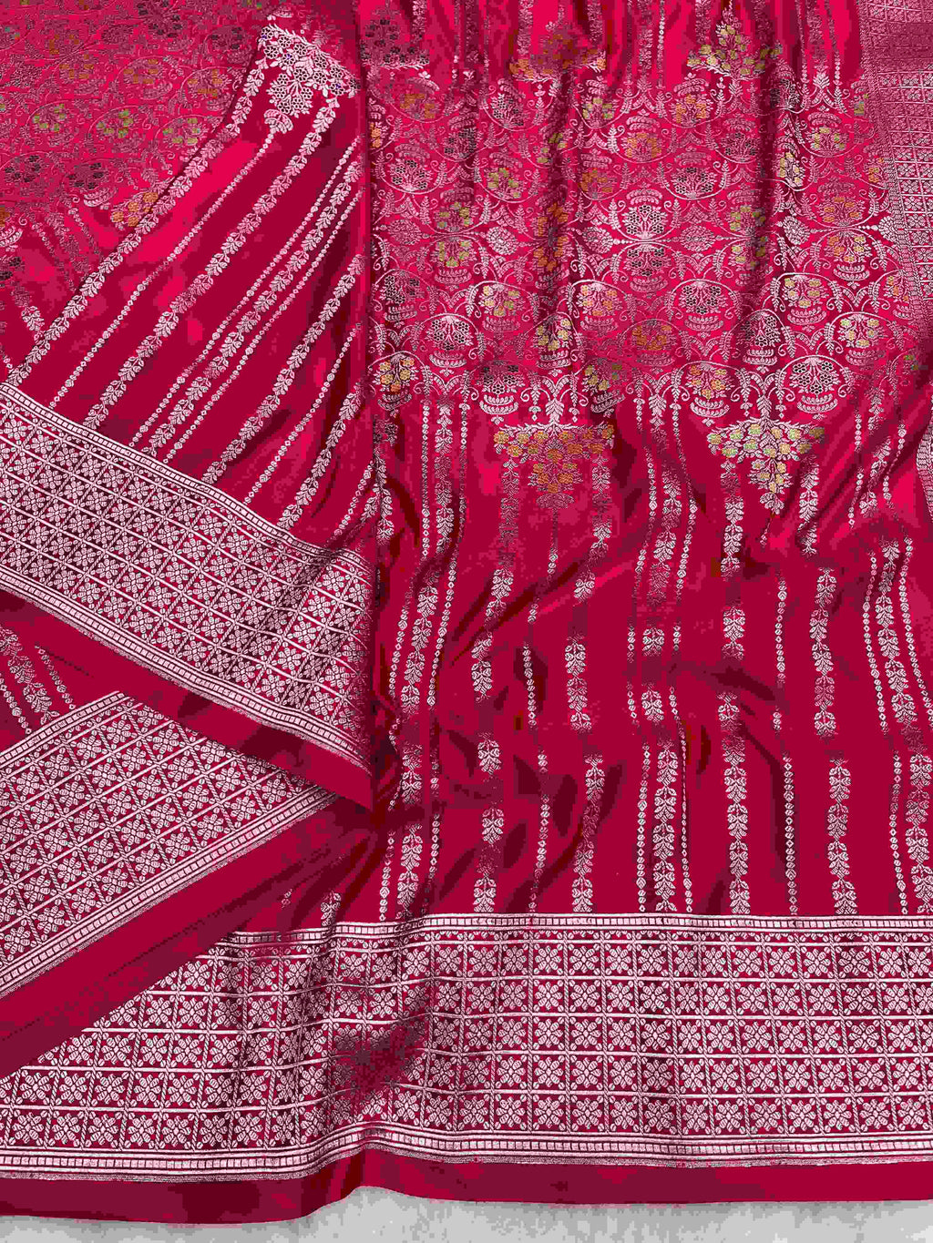 Rani Pink Banarasi mashru soft silk saree woven with intricate golden zari floral jangla jaal, vertical pinstripes, meenakari accents, and geometric borders.