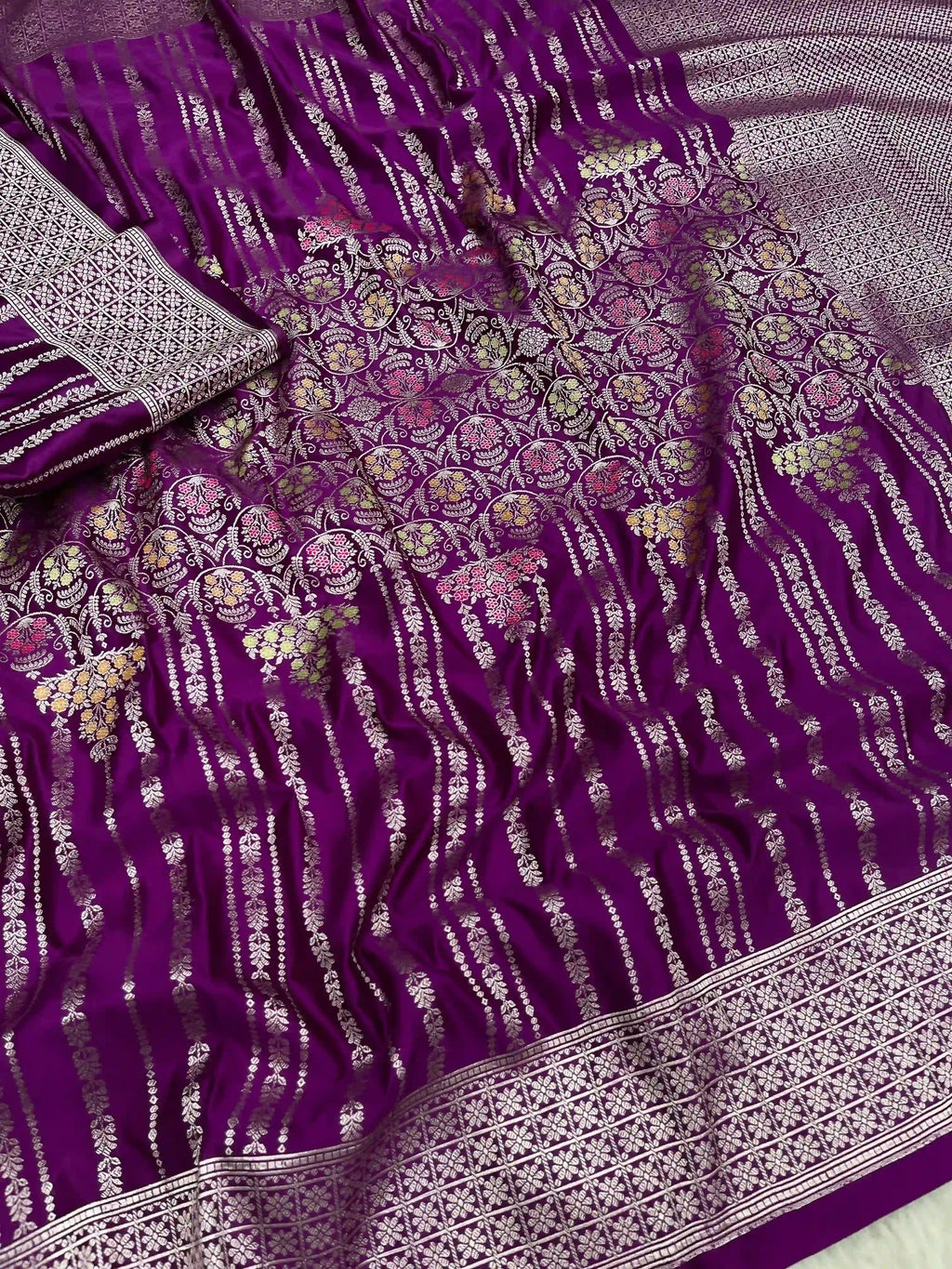 Purple Banarasi mashru soft silk saree featuring intricate golden zari floral jangla weaving, vertical pinstripes, meenakari highlights, and a ornate zari border.