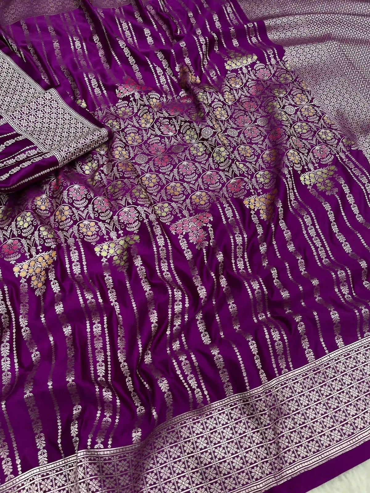 Purple Banarasi mashru soft silk saree featuring intricate golden zari floral jangla weaving, vertical pinstripes, meenakari highlights, and a ornate zari border.