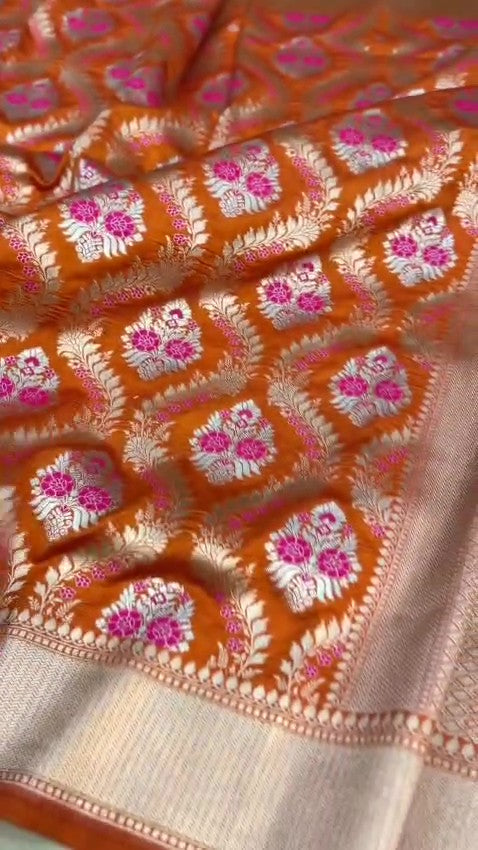 Orange Banarasi handloom pure chiniya silk saree featuring intricate silver sona roopa meenakari patterns.