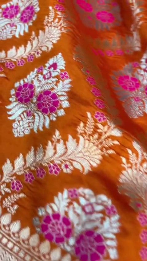 Orange Banarasi handloom pure chiniya silk saree featuring intricate silver sona roopa meenakari patterns.