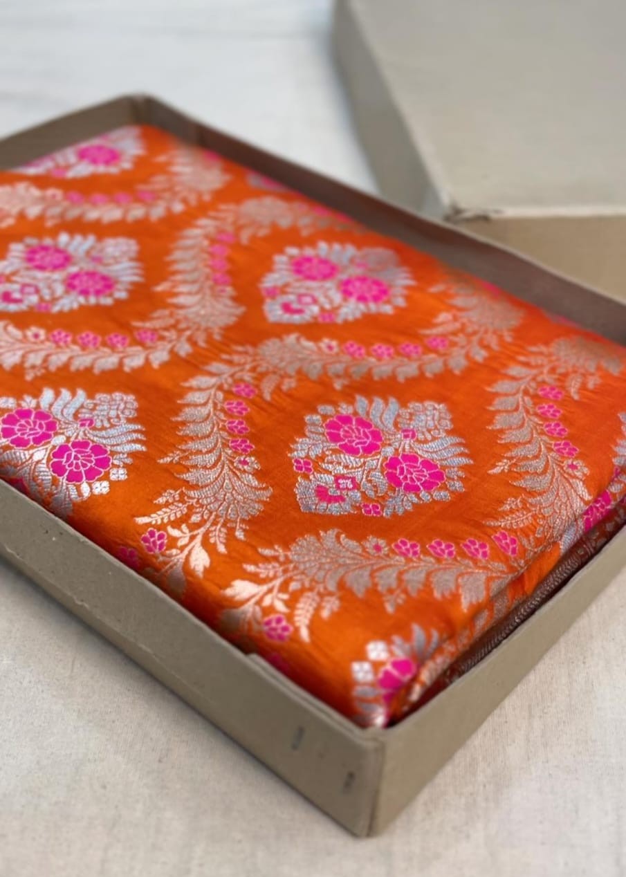 Orange Banarasi handloom pure chiniya silk saree featuring intricate silver sona roopa meenakari patterns.