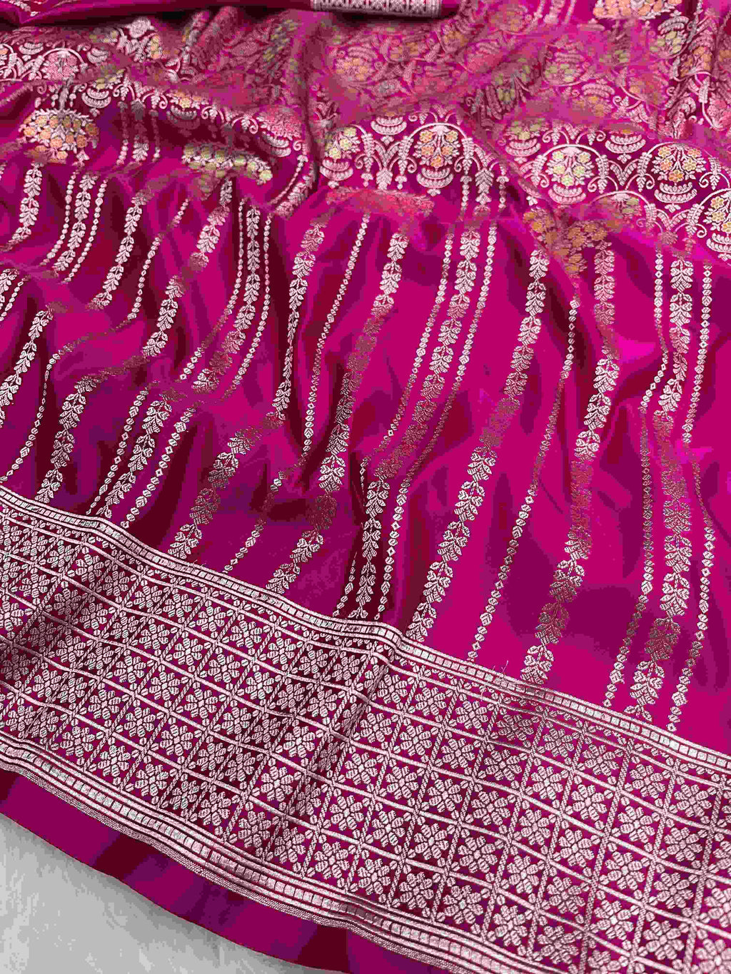 Hot pink Banarasi mashru soft silk saree detailed with all-over golden zari floral jangla weaving, meenakari highlights, and intricate zari borders.