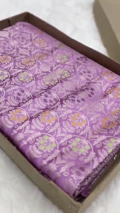 Folded lavender Banarasi mashru soft silk saree featuring intricate all-over floral jangla weave and subtle meenakari detailing.
