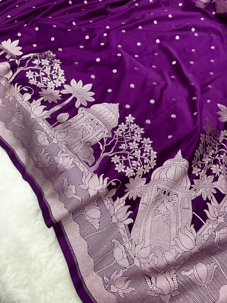 Elegant purple Banarasi Mashru soft silk saree detailed with shimmering silver zari woven borders and pallu.