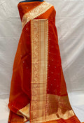 Banarasi Handloom Kora Organza Silk Saree in deep green with intricate zari Kaduwa floral motifs and a rich contrast red brocade border with Silk Mark tag.
