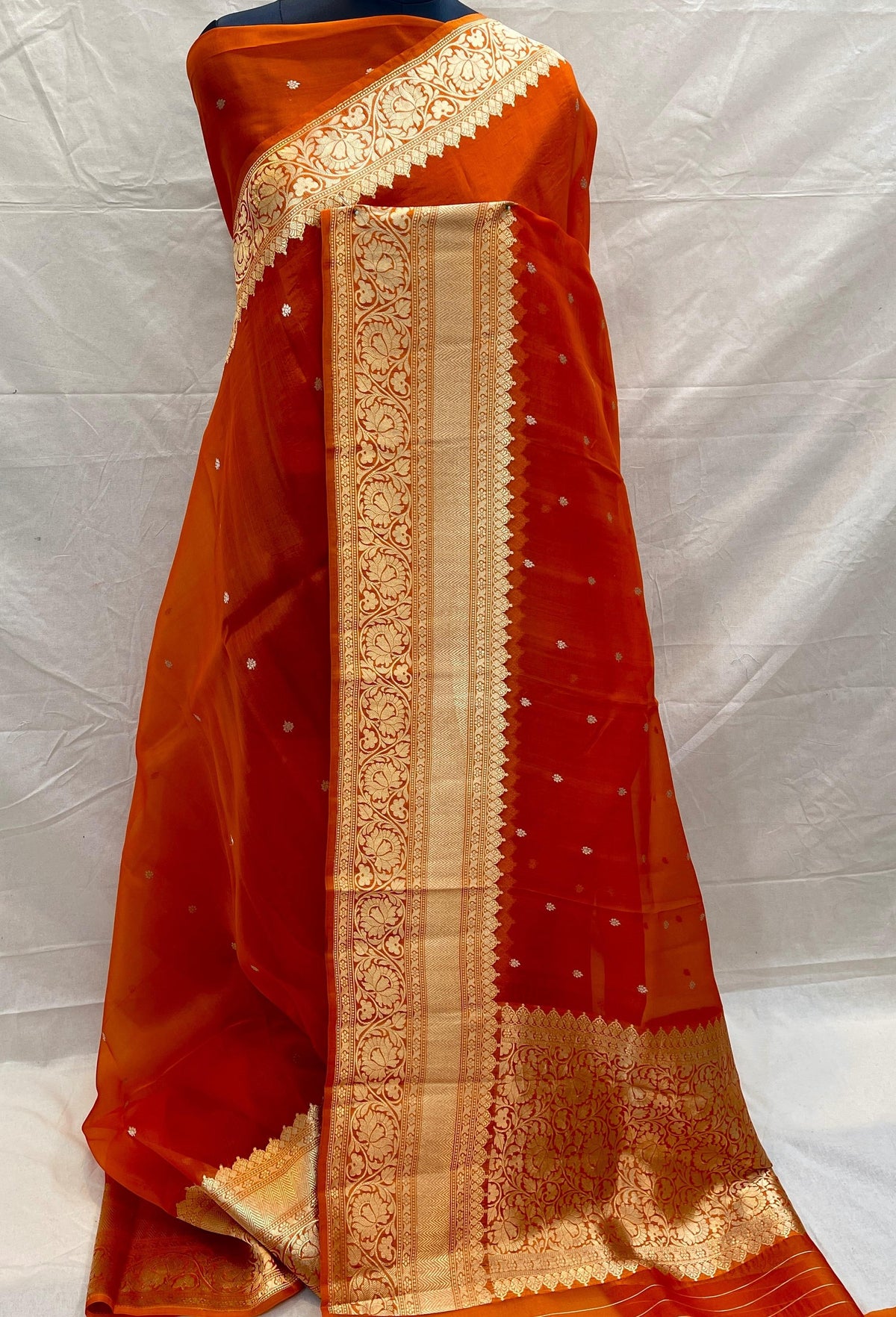 Banarasi Handloom Kora Organza Silk Saree in deep green with intricate zari Kaduwa floral motifs and a rich contrast red brocade border with Silk Mark tag.