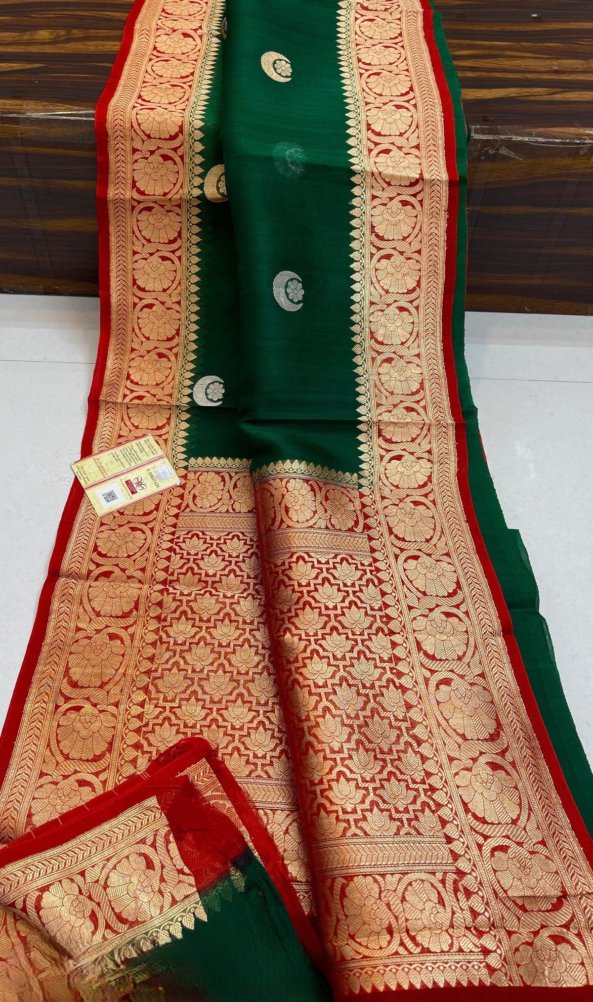 Banarasi Handloom Kora Organza Silk Saree in deep green with intricate zari Kaduwa floral motifs and a rich contrast red brocade border with Silk Mark tag