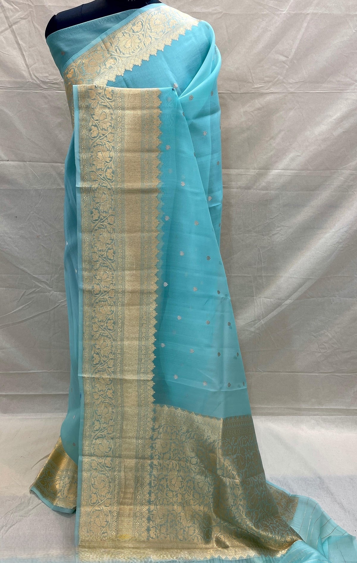 Banarasi Handloom Kora Organza Silk Saree in deep green with intricate zari Kaduwa floral motifs and a rich contrast red brocade border with Silk Mark tag.