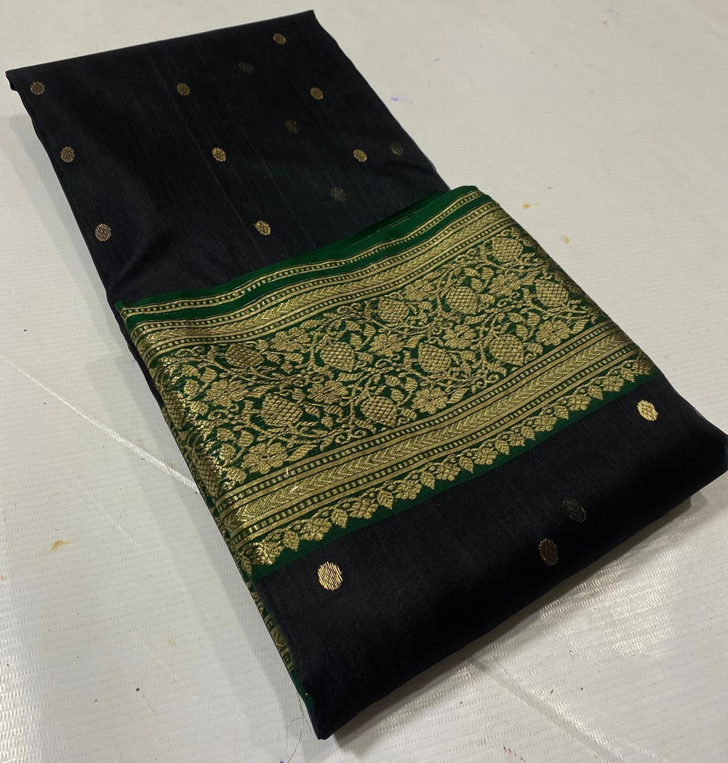 Black Chanderi handloom katan silk saree featuring intricate green and gold woven borders with small gold motifs.