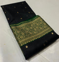 Black Chanderi handloom katan silk saree featuring intricate green and gold woven borders with small gold motifs.