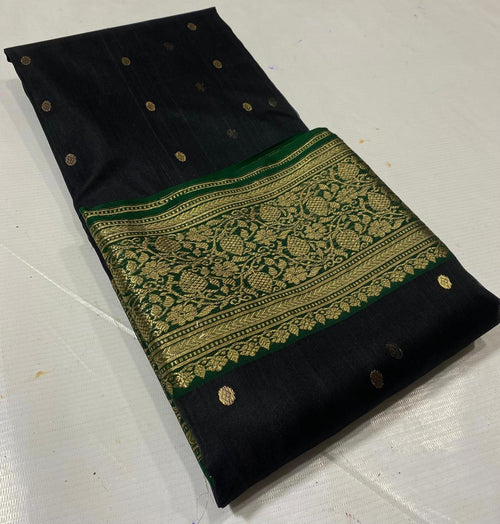Black Chanderi handloom katan silk saree featuring intricate green and gold woven borders with small gold motifs.