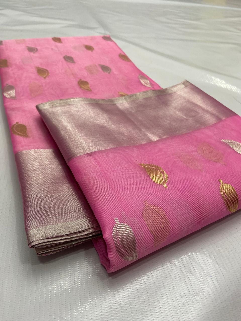 Pink Chanderi handloom katan silk saree featuring gold and silver zari borders and leaf buttas.