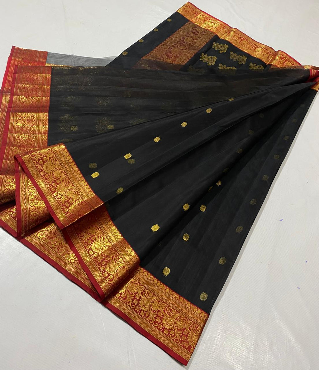 Black Chanderi handloom katan silk saree featuring intricate green and gold woven borders with small gold motifs.