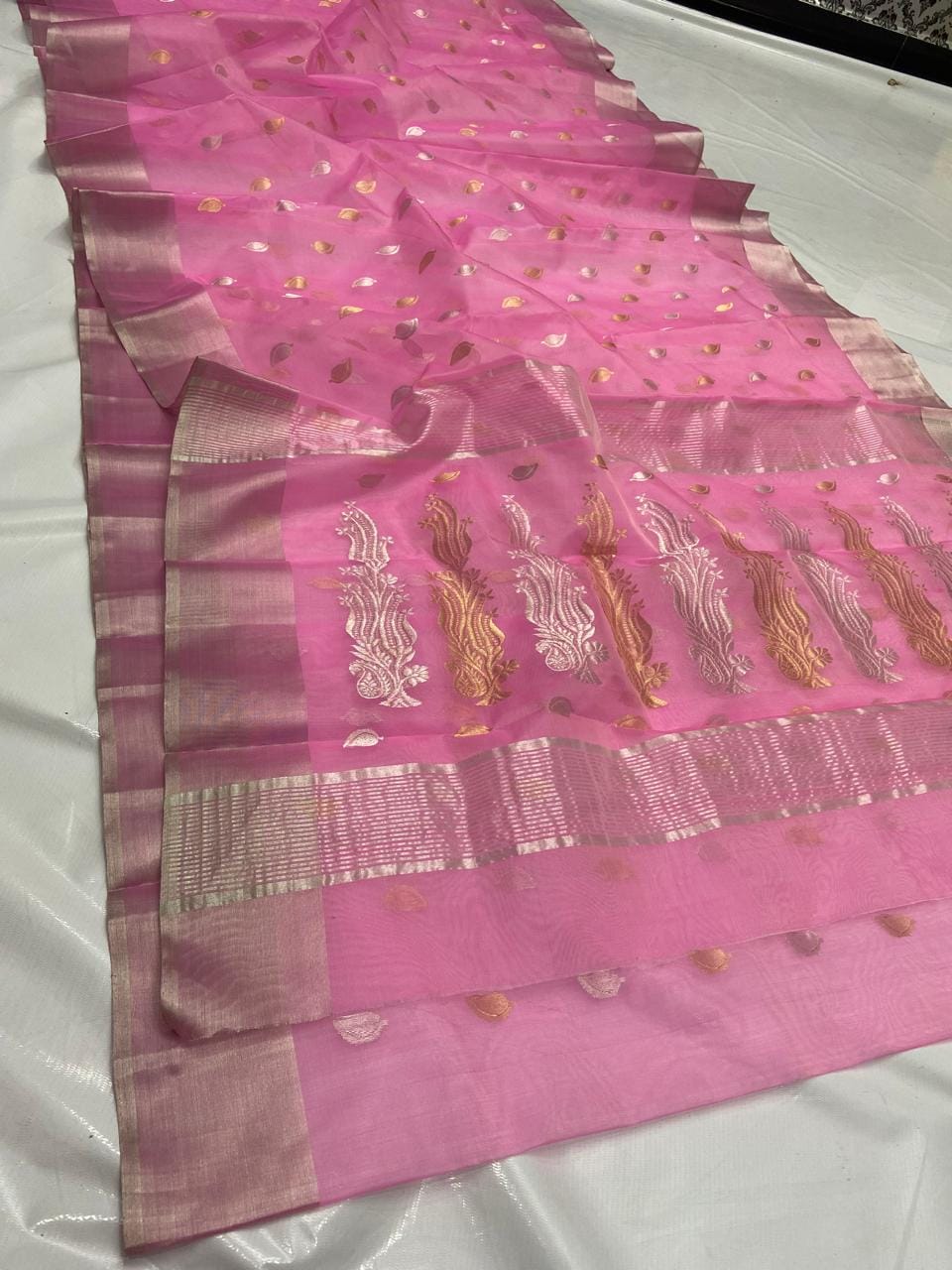 Pink Chanderi handloom katan silk saree featuring gold and silver zari borders and leaf buttas.