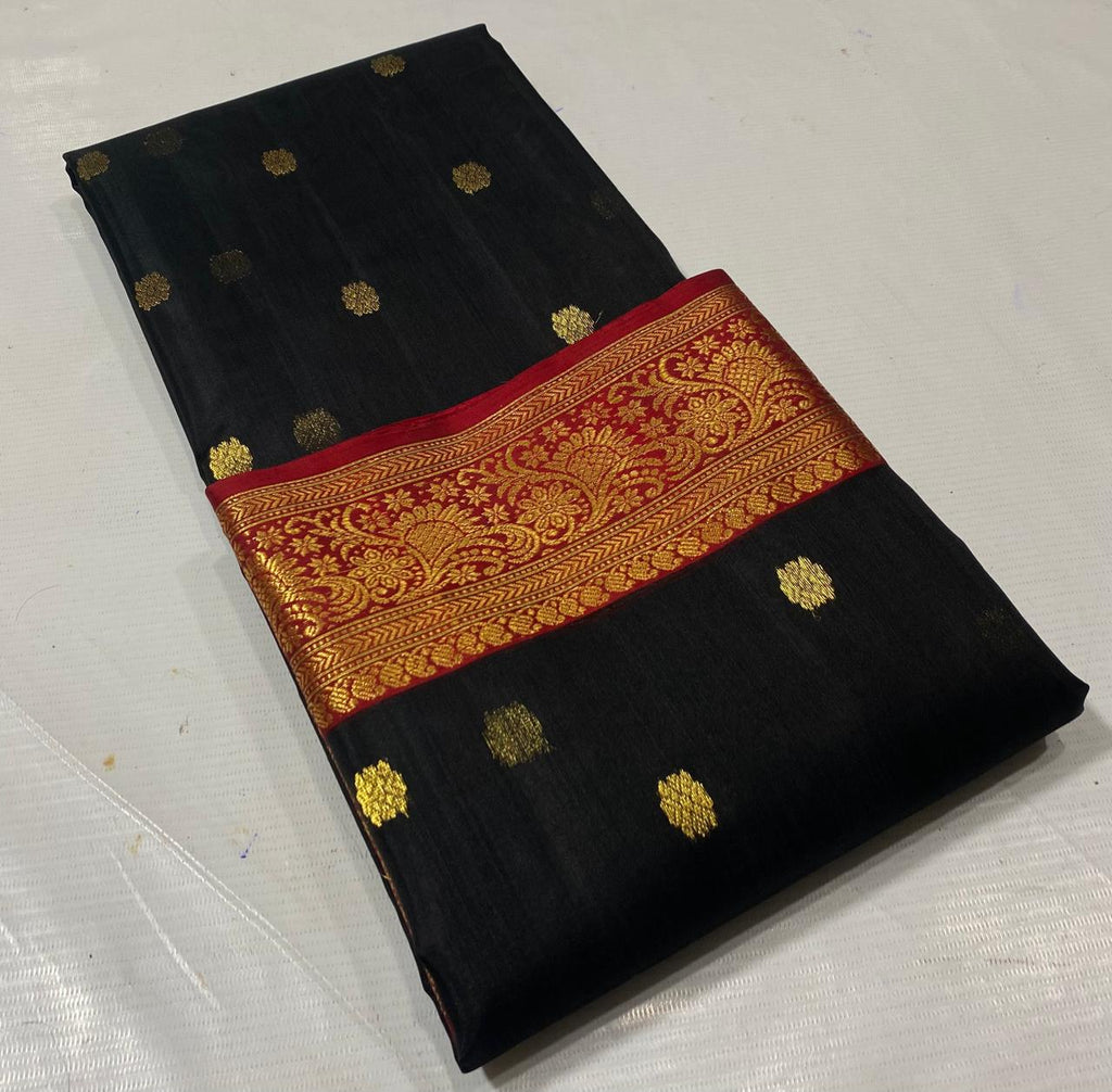 Black Chanderi handloom katan silk saree featuring intricate green and gold woven borders with small gold motifs.