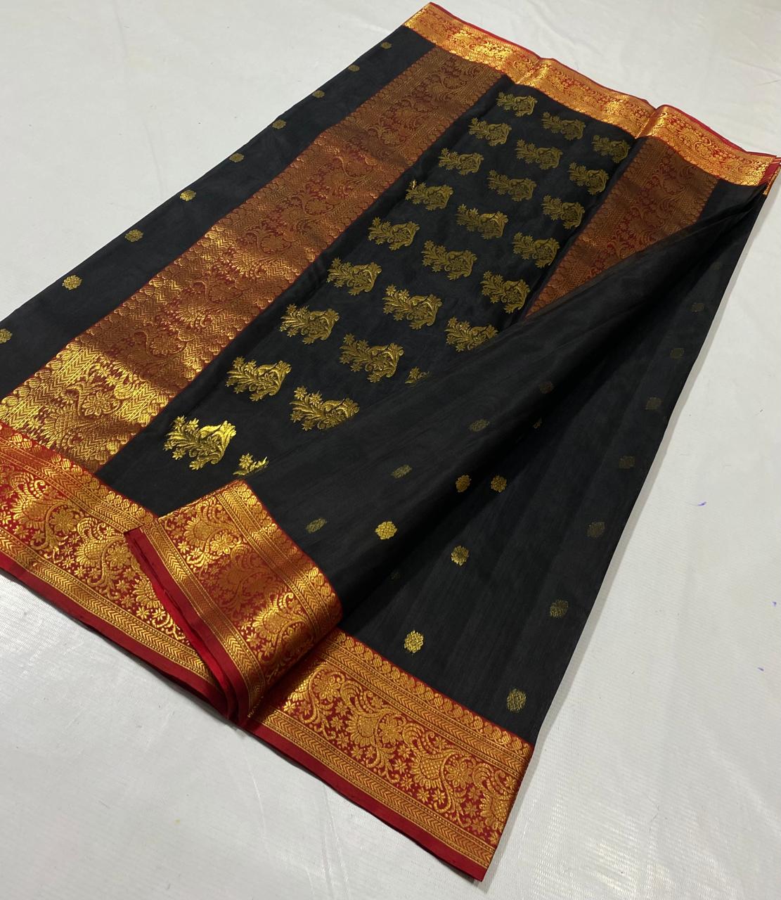 Black Chanderi handloom katan silk saree featuring intricate green and gold woven borders with small gold motifs.