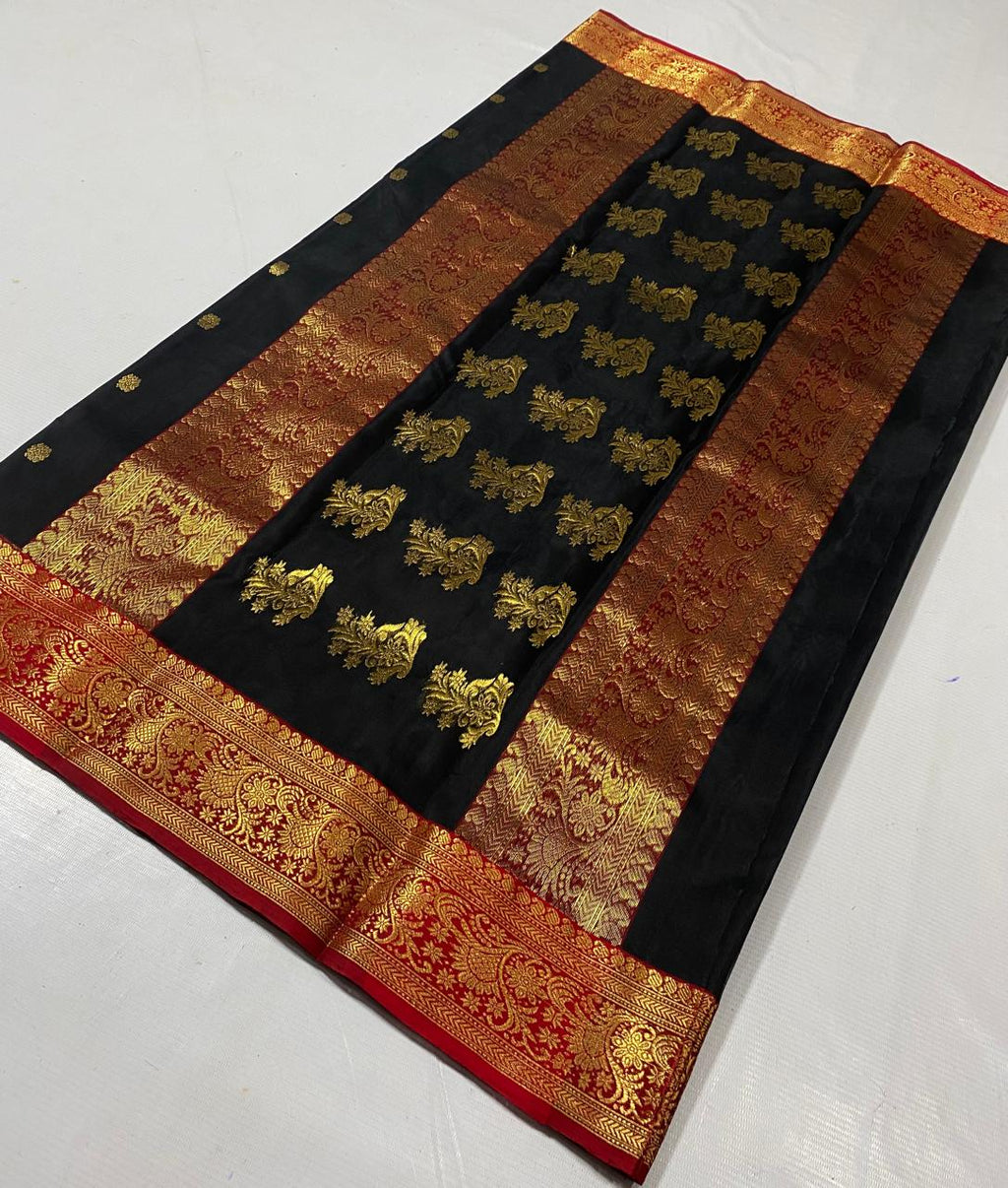 Black Chanderi handloom katan silk saree featuring intricate green and gold woven borders with small gold motifs.