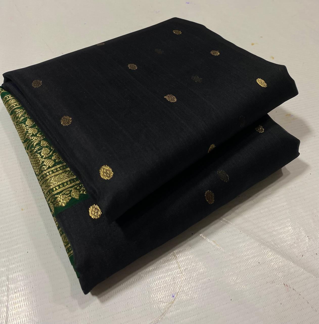 Black Chanderi handloom katan silk saree featuring intricate green and gold woven borders with small gold motifs.