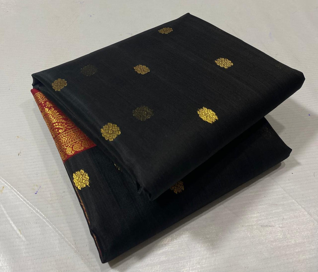 Black Chanderi handloom katan silk saree featuring intricate green and gold woven borders with small gold motifs.