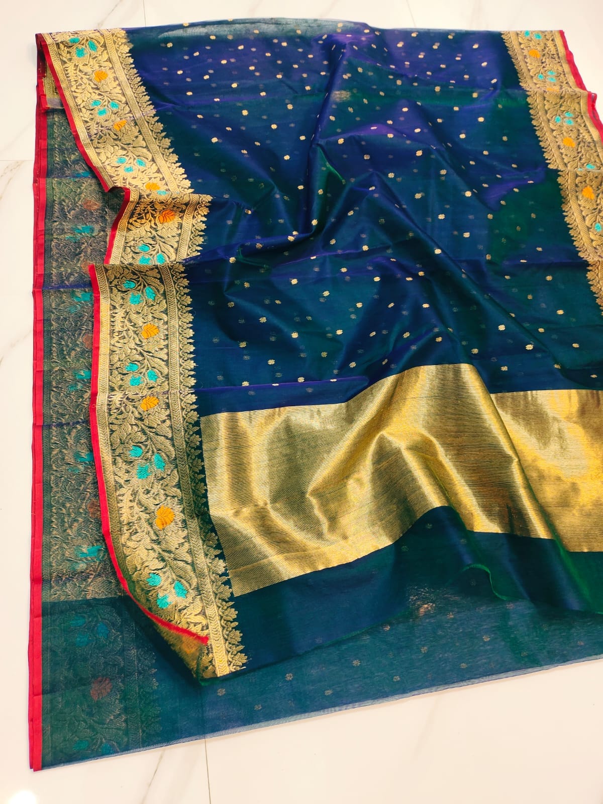Peacock Blue Chanderi handloom katan silk saree featuring intricate multicolored meenakari handwork and gold zari borders.