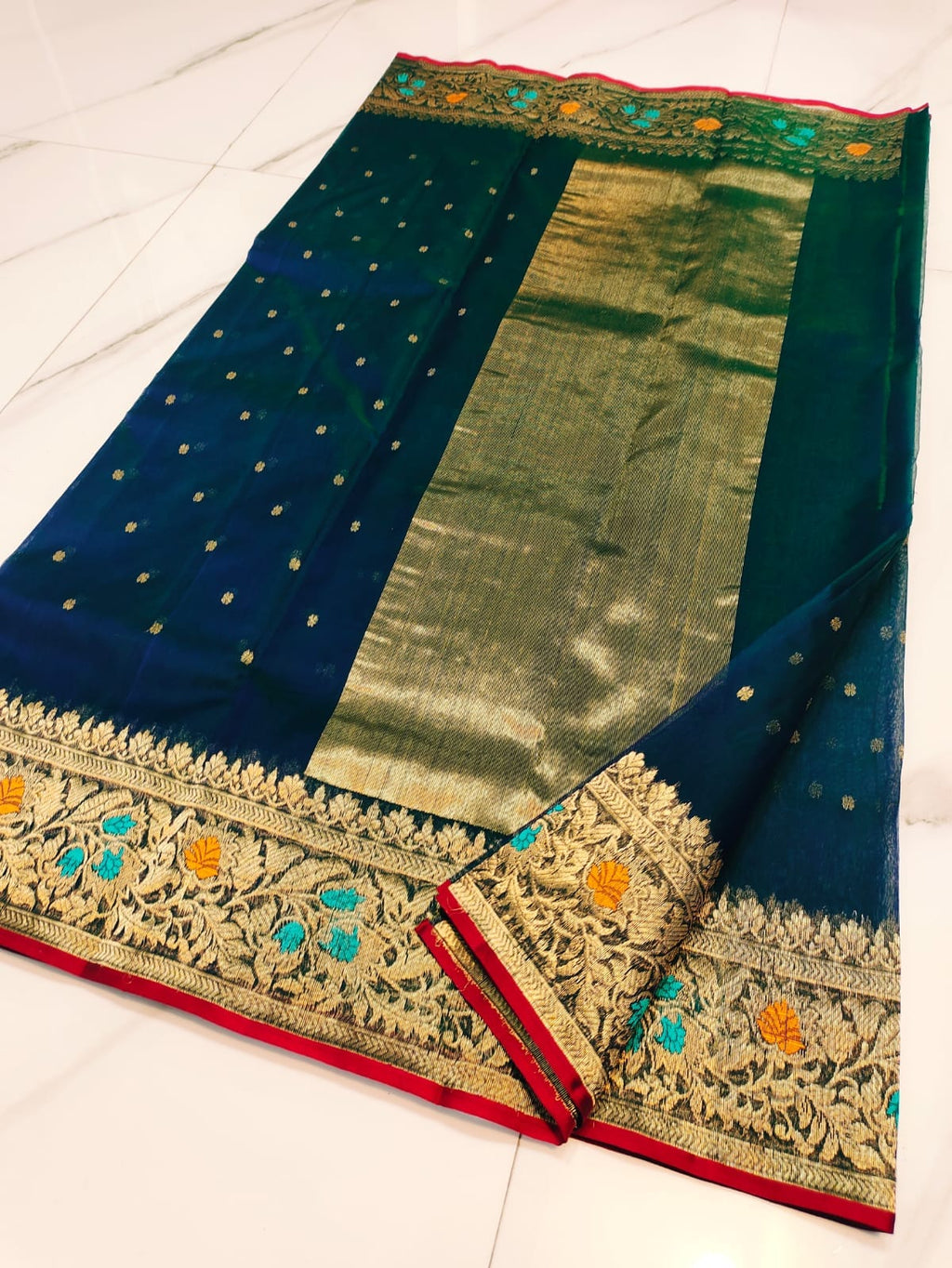 Peacock Blue Chanderi handloom katan silk saree featuring intricate multicolored meenakari handwork and gold zari borders.