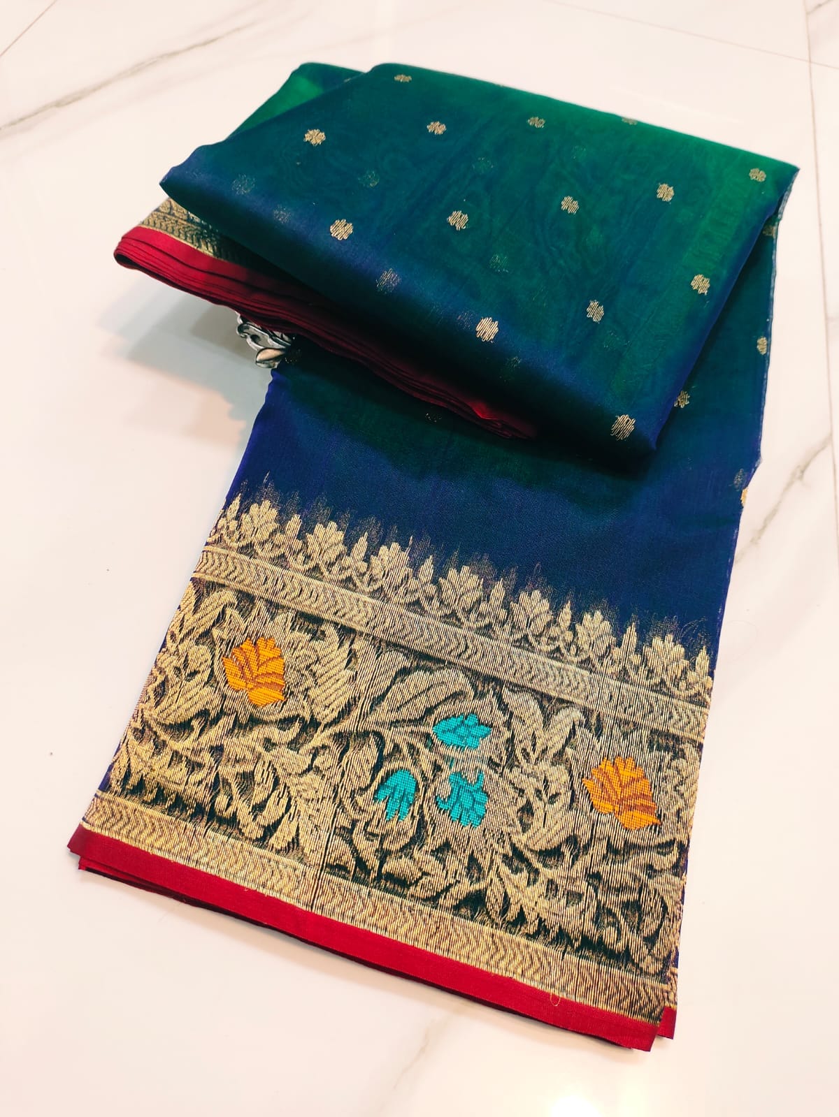 Peacock Blue Chanderi handloom katan silk saree featuring intricate multicolored meenakari handwork and gold zari borders.