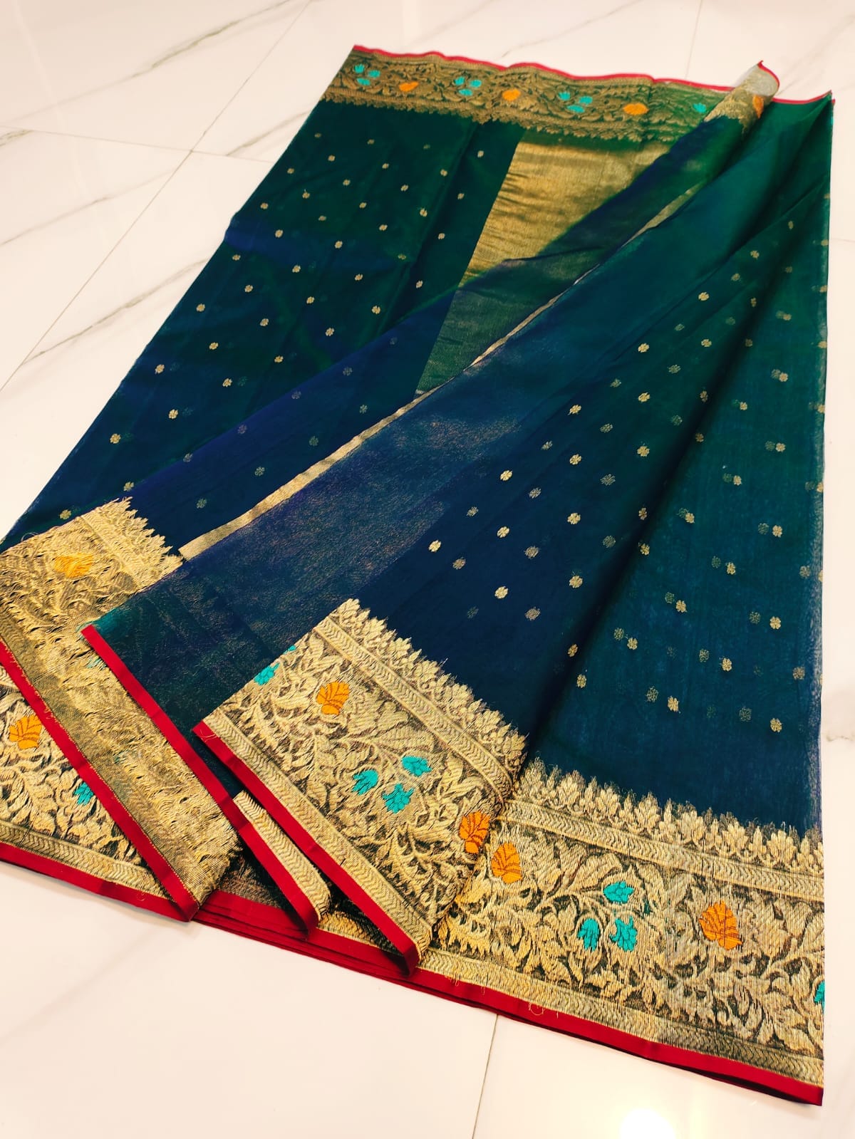 Peacock Blue Chanderi handloom katan silk saree featuring intricate multicolored meenakari handwork and gold zari borders.