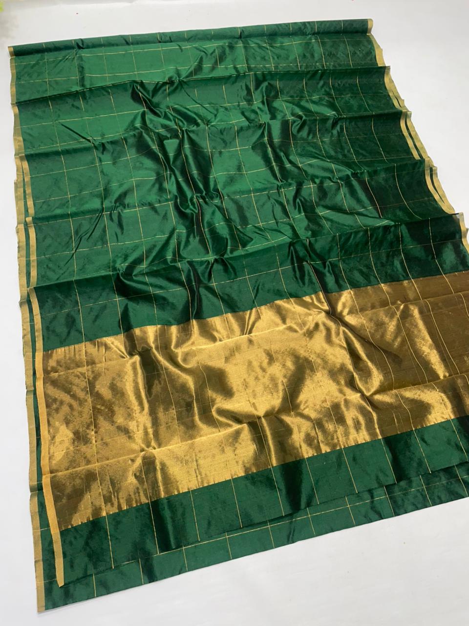 Bottle Green Chanderi handloom pattu silk saree featuring all over zari checks in the body and traditional rich zari weaving.