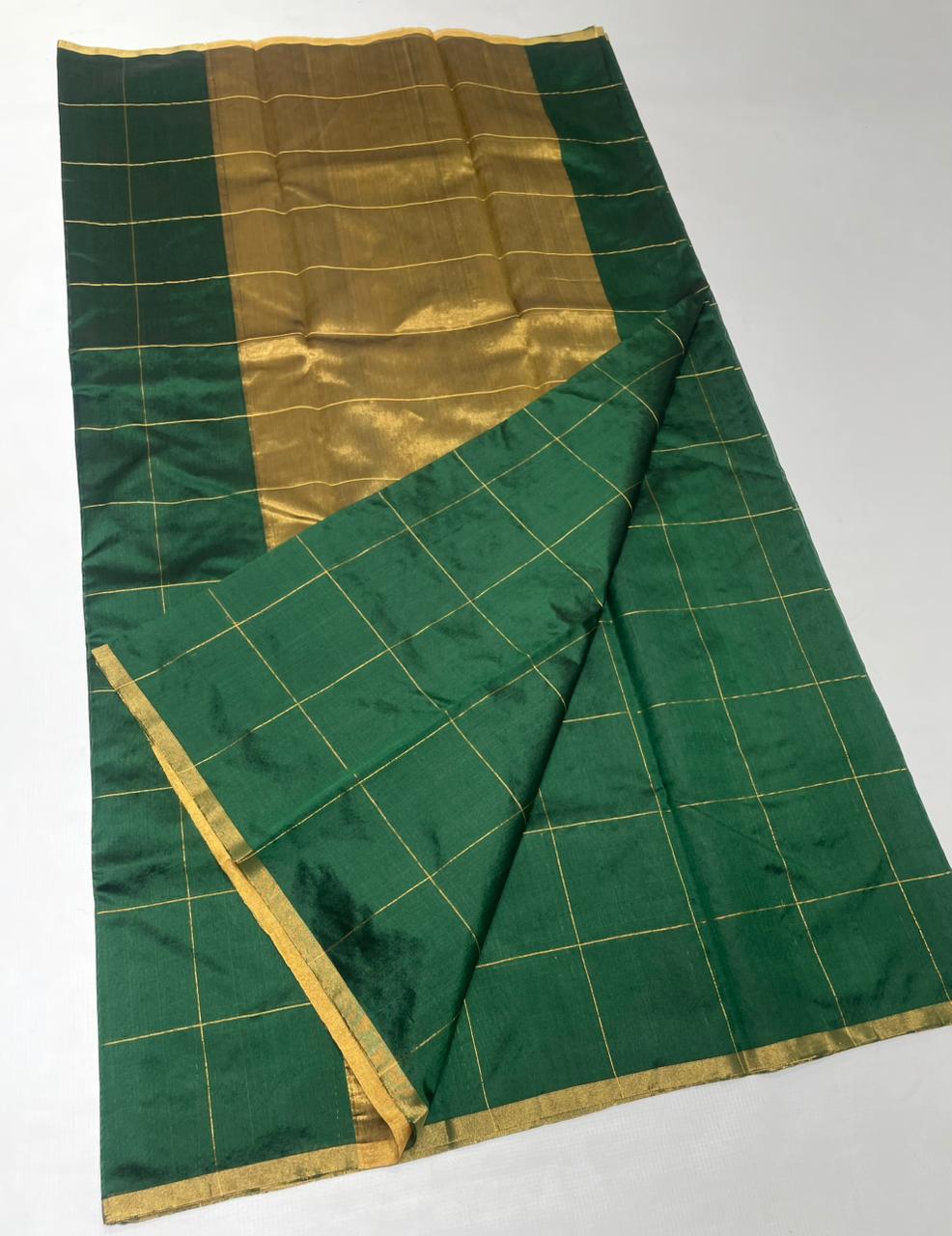 Bottle Green Chanderi handloom pattu silk saree featuring all over zari checks in the body and traditional rich zari weaving.