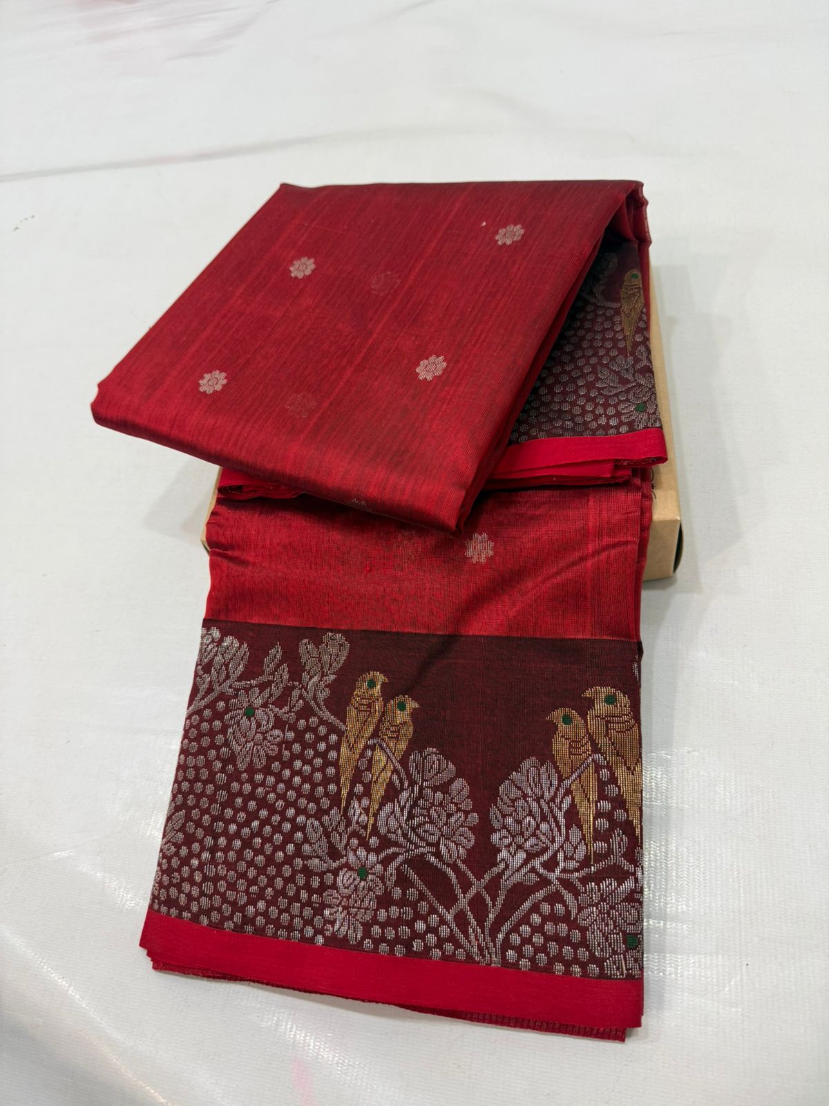 Chanderi handloom pattu silk saree featuring a dark maroon zari border with intricate gold bird motifs, styled with a matching blouse