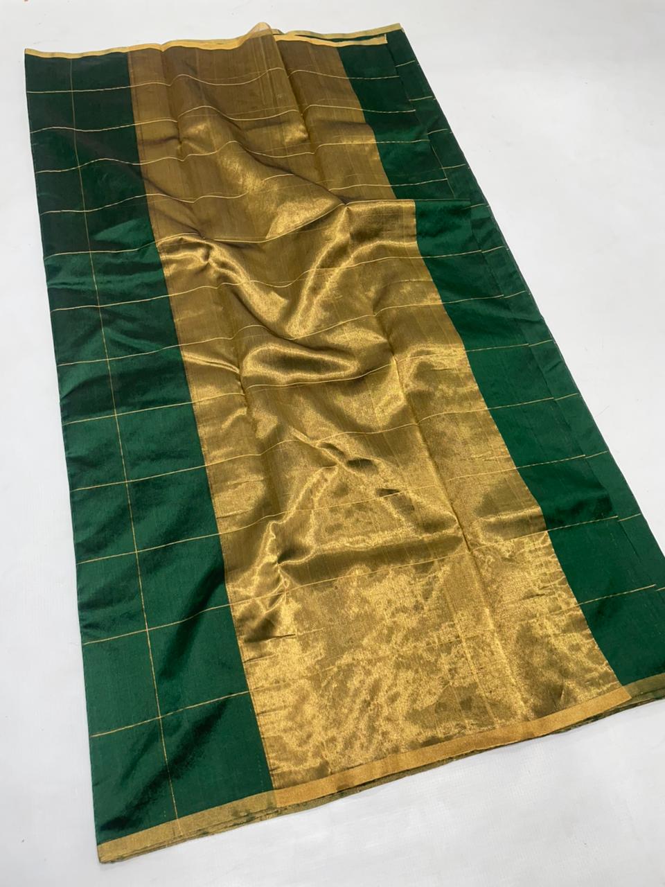 Bottle Green Chanderi handloom pattu silk saree featuring all over zari checks in the body and traditional rich zari weaving.