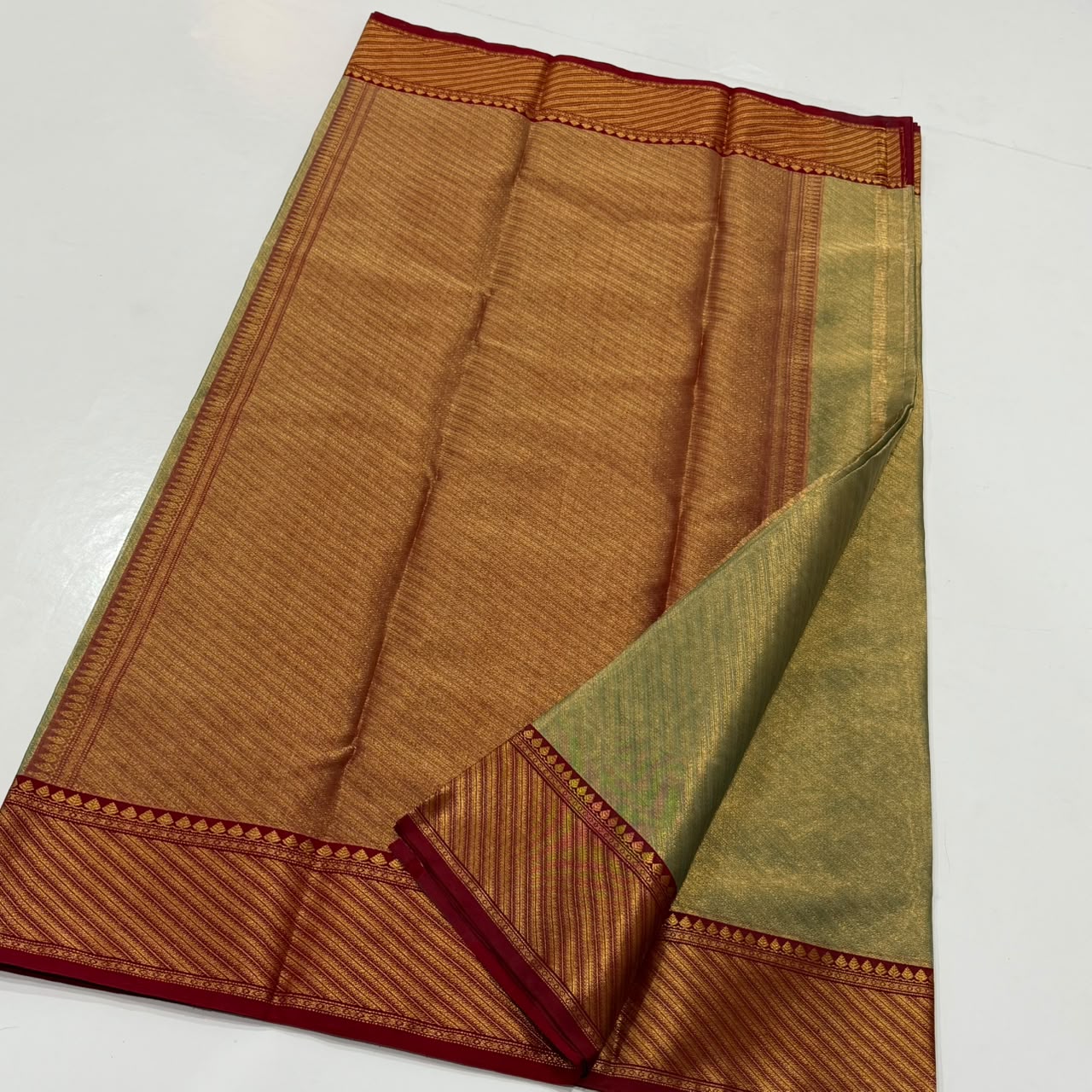 Dual-tone olive green and gold Chanderi Handloom Katan Silk saree with a rich maroon border and intricate Nakshi weaving.