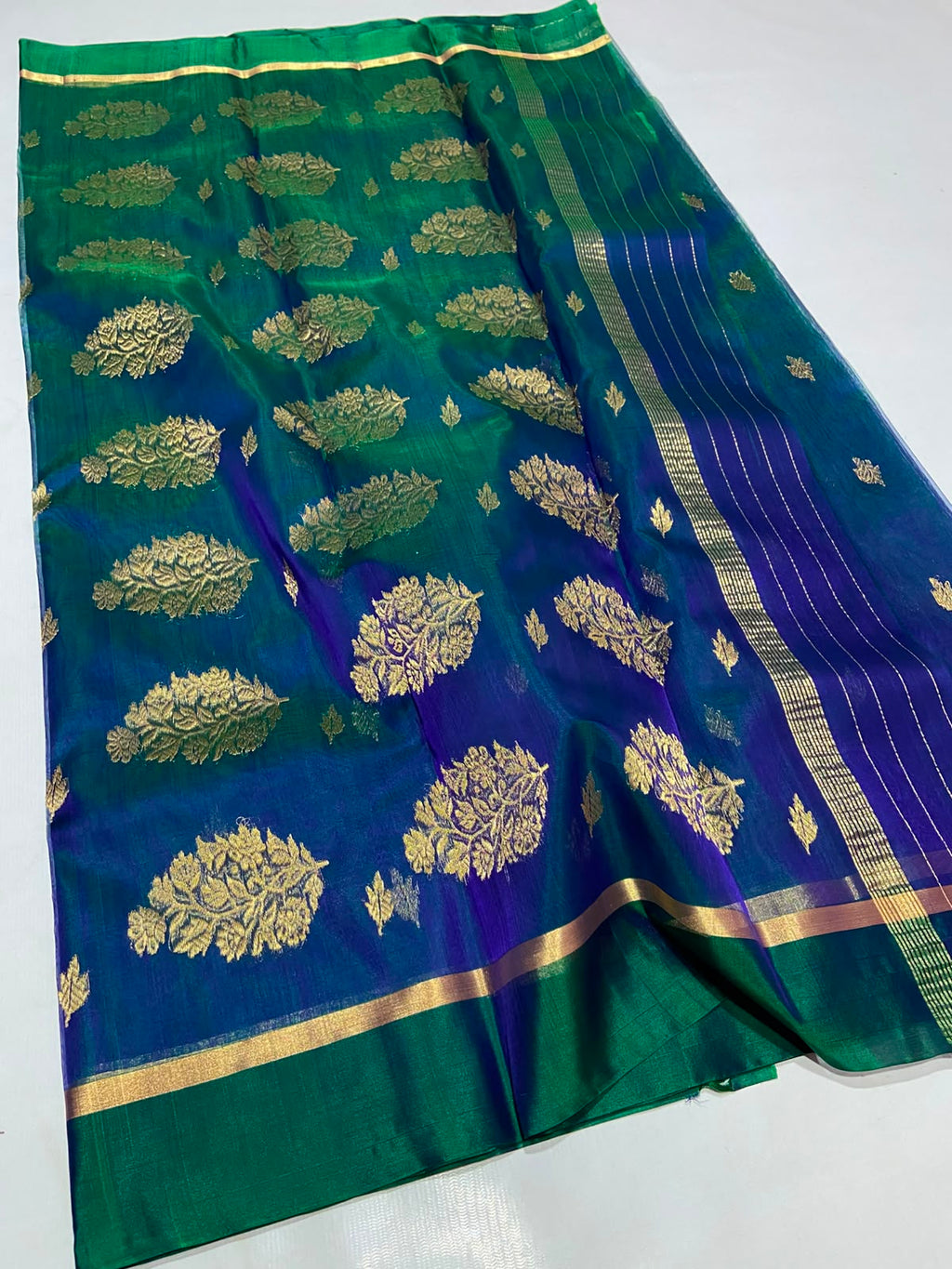 Dual Tone Peacock Blue Chanderi Handloom Katan Silk saree with gold zari motifs.