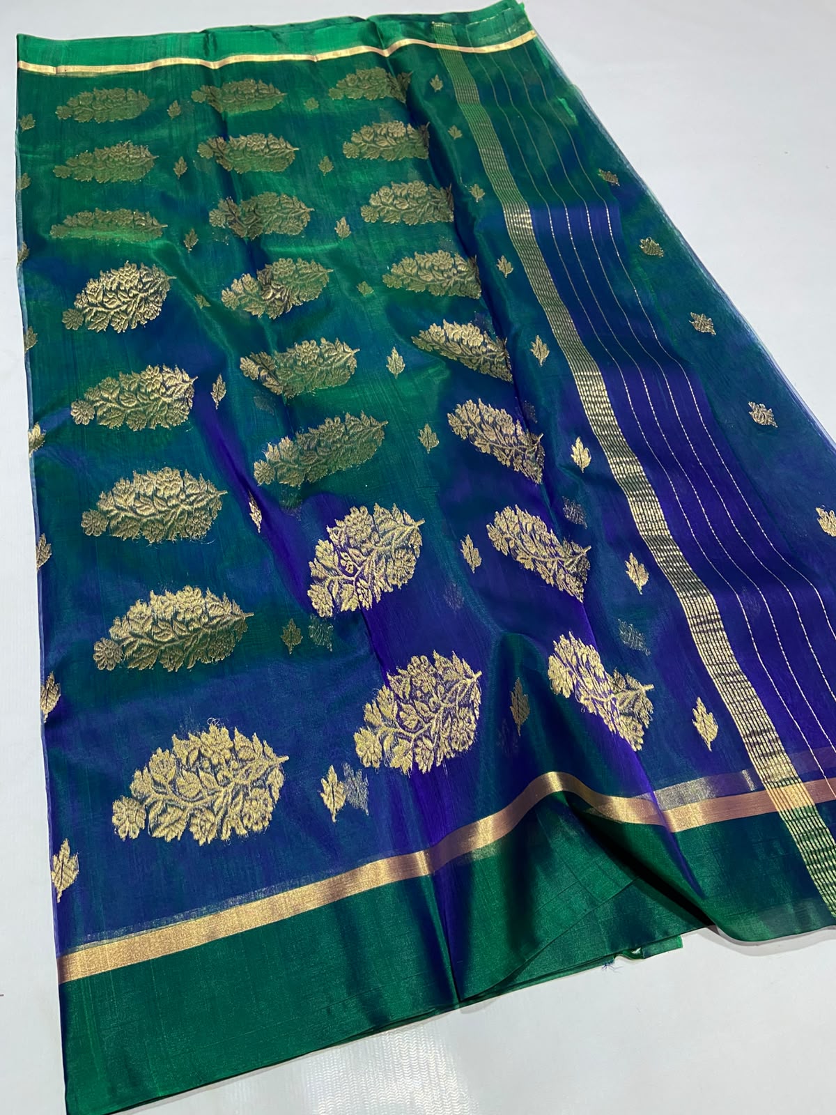 Dual Tone Peacock Blue Chanderi Handloom Katan Silk saree with gold zari motifs.