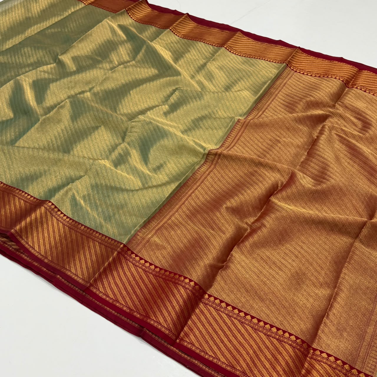 Dual-tone olive green and gold Chanderi Handloom Katan Silk saree with a rich maroon border and intricate Nakshi weaving.